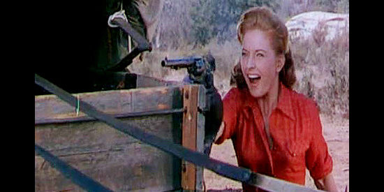Coleen Gray as Christella Burke, jumping into action during an Indian attack in Arrow in the Dust (1954)