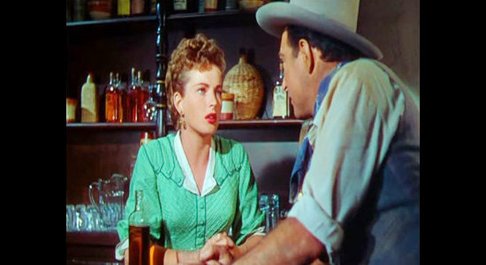 Coleen Gray as Sally, trying to explain her feelings to Sam Leeds while he's handcuffed to a saloon bar in Apache Drums (1951)