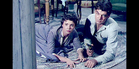 Colleen Miller as Lloy Bhumer and Rory Clahoun as Ray Cully ducking as the posse catches up in Four Guns to the Border (1954)