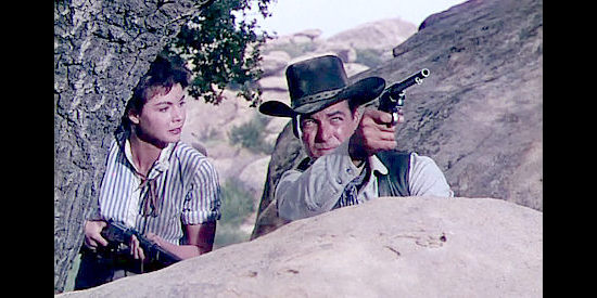 Colleen Miller as Lolly Bhumer and Rory Calhoun as Ray Cully trying to fight off an Apache attack in Four Guns to the Border (1954)