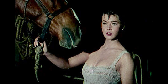 Colleen Miller as Lolly Bhumer, looking for mischief in the stable in Four Guns to the Border (1954)