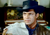 Dale Robertson as John Banner, presented with a wanted posters in Dakota Incident (1956)
