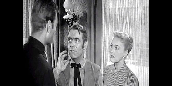 Dan Riss (center) as Marshal McAfee, talking to Pat Garrett (George Montgomery) and Lorna (Karin Booth) about brewing trouble in Badman's Country (1958)