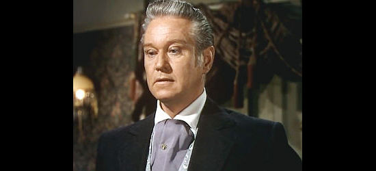 David Brian as Dick Braden, informing Rannah of her place in his saloon in Dawn at Socorro (1954)