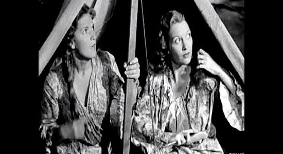 Denise Darcel as Fifi Danon and Julie Bishop as Laurie Smith, startled by an approaching storm in Westward the Women (1951)