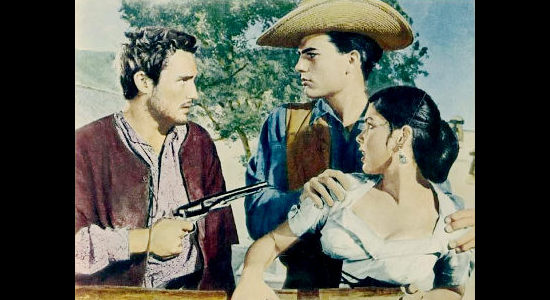 Dennis Hopper as Hatfield Carnes, threatening Elena de la Madrid (Yvonne Craig) in front of boyfriend Sheriff Jim Ellison (Patrick Wayne) in The Young Land (1959)