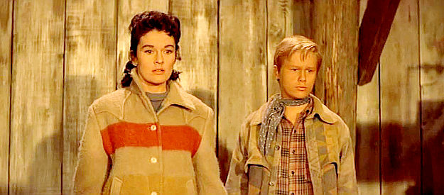 Dianne Foster as Charlotte Drew and Brandon De Wilde as Joey watch the results of a climatic shootout in Night Passage (1957)