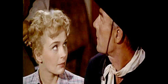 Dolores Dorn as Julie Spencer with Randolph Scott as Jim Kipp after her father has been wounded in The Bounty Hunter (1954)