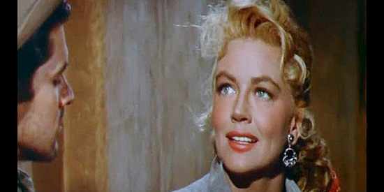 Dorothy Malone, smiling at the memory of her youthful beauty and innocence in Quantez (1957)