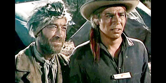 Douglas Spencer as fur trapper Garode and Pat Hogan as Indian scout Delche, coming up with a plan for getting information from a captured Ute in Smoke Signal. (1955)