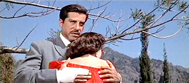 Eduardo Noriega as Enrique Rios, consoling the woman he plans to marry in The Beast of Hollow Mountain (1956)