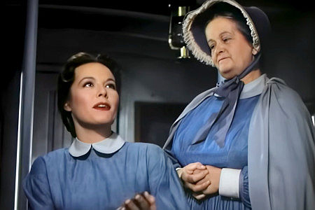Elizabeth Slifer as Sister Wallace, listening to Alicia Chadwick (Eve Miller) talk fondly of Jim Fallon in The Big Trees (1952)