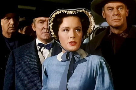 Eve Miller as Alicia Chadwick, determined to protect the California redwoods that serve as a church to her congregation in The Big Trees (1952)