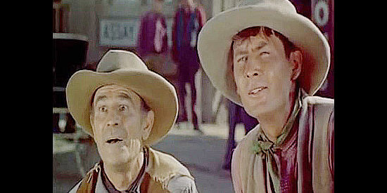 Fess Parker (right) as a rowdy cowboy scared out of Twin Forks when he learns of JIm Kipp's presence in The Bounty Hunter (1954)