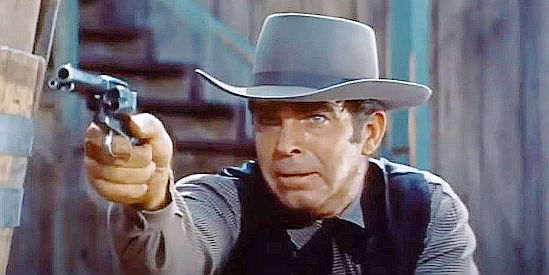 Fred MacMurray as Jack Wright, determined to defend his right to stay in Plainview in At Gunpoint (1955)