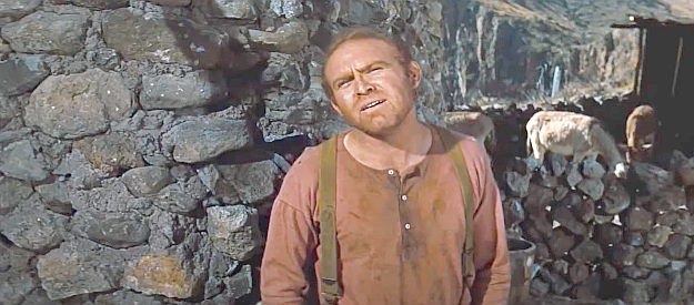Gene Evans as John Butler, Jim Douglass' neighbor, wary of two strange riders who show up on his property in The Bravados (1958)