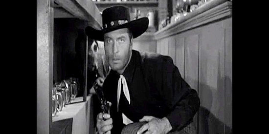 George Montgomery as Pat Garrett, in a saloon shoot-out with Sundance and his men in Badman's Country (1958)