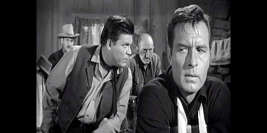George Montgomery as Pat Garrett, listening in on the outlaw's plans while held captive in their lair in Badman's Country (1958)