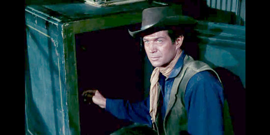 George Nadar as Bronco, helping himself to the contents of the safe in Four Guns to the Border (1954)