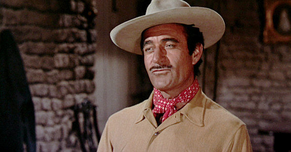 Gilbert Roland as Innocencio Ortega, longtime foreman for Colt Saunders, welcoming Lorna to her new home in Three Violent People (1957)