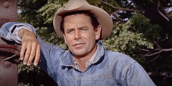 Glenn Ford as Sam Dent, planning a trip to Brazil to sell three prized Burma bulls in The Americano (1955)