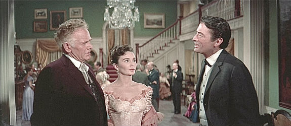 Gregory Peck as James McKay, at his engagement party with Maj. Terrell (Charles Bickford) and Julie Maragon (Jean Simmons) in The Big Country (1958)