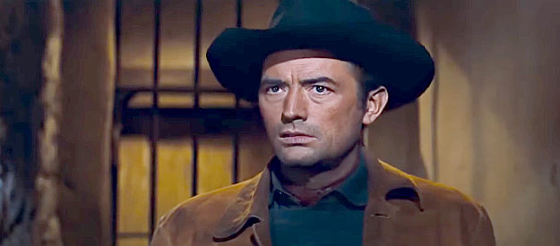 Gregory Peck as Jim Douglass, wanting to get a glimpse of the four men he's been tracking for months in The Bravados (1958)