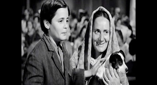 Guido Martufi as Anthony Moroni, ready for the trip West with his mother (Renata Vanni) and his puppy in Westward the Women (1951)