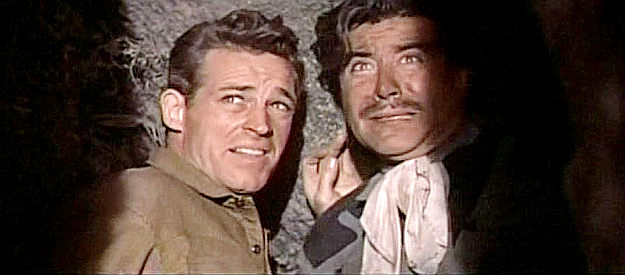 Guy Madison as Jimmy Ryan and Eduardo Noriega as Enrique Rios, hiding in a cave from the beast in The Beast of Hollow Mountain (1956)