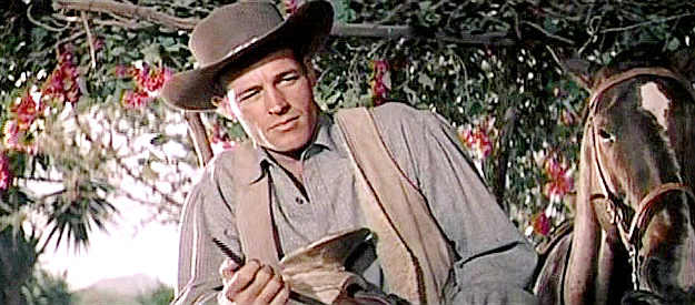 Guy Madison as Jimmy Ryan, wondering what to do about an offer to sell his ranch to a rival in The Beast of Hollow Mountain (1956)