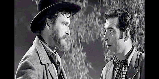 Henry Brandon as Jesse James, doling out advice about life as an outlaw to Vic Rodell (Stephen McNally) in Hell's Crossroads (1957)