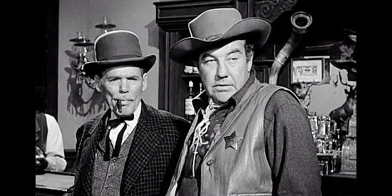 Henry Hull as Ollie Stokely and Broderick Crawford as Sheriff Frazer, watching a fight break out in The Last Posse (1953)