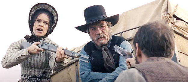 Hilary Swank as Mary Bee Cuddy and Tommy Lee Jones as George Briggs in a dispute with one of the husbands in The Homesman (2014)