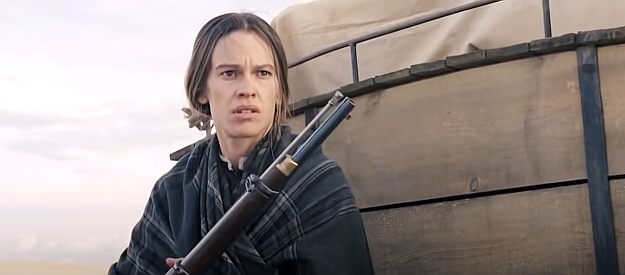 Hilary Swank as Mary Bee Cuddy, ready to defend the women she's transporting in The Homesman (2014)
