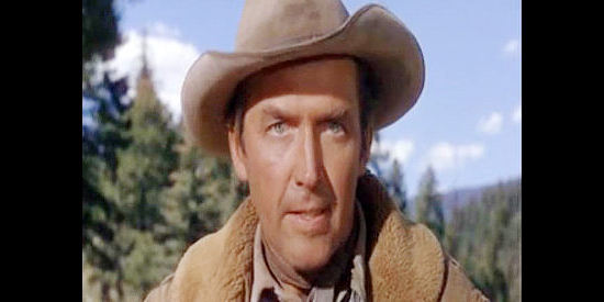 James Stewart as Howard Kemp, a bounty man who reluctantly takes on two partners in The Naked Spur (1953)