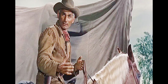 Jeff Chandler as Lon Bennett, taking time out from his guide duties to teach the Basque children a bit of English in Thunder in the Sun (1959)