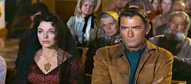 Joan Collins as Josefa Velarde and Gregory Peck as Jim Douglass, attending mass together in The Bravados (1958)