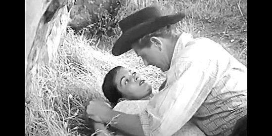 Joan Taylor as Ann LeBeau, pinned down by Rex Moffett after she tried to bash him in the head with a rock in Apache Woman (1955)