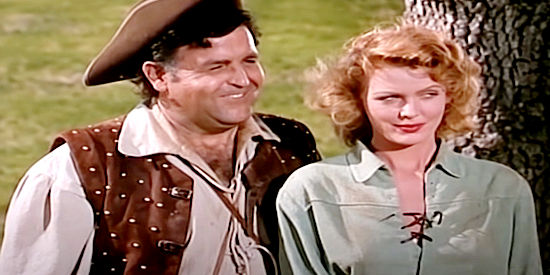 Joan Vohs as Fortune Mallory with Ben Astor as Francios Leroy watching Running Otter's welcome for Capt. Horn in Fort Ti (1953)