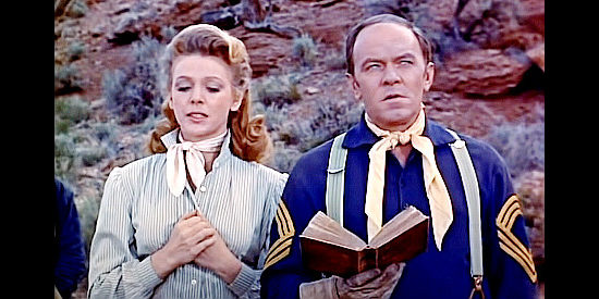 Joan Vohs as Melanie Crown and William 'Bill' Phillips as Sgt. Milo Hallock at the funeral of two troopers in Fort Yuma (1955)