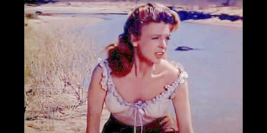 Joan Vohs as Melanie Crown, saved from an Apache brave by Sgt. Jonas in Fort Yuma (1955)