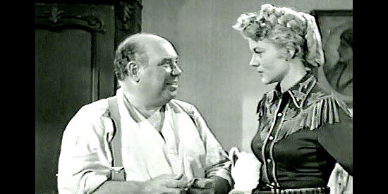 Joe Besser as Doc McGinnis, unsure if he revealed the secret of why Kate Masters (Peggie Castle) is performing in a small Western town in Two-Gun Lady (1955)