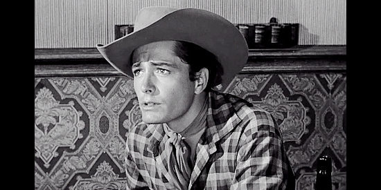 John Derek as Jed Clayton, a young man devoted to Sampson Drune in The Last Posse (1953)