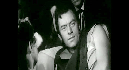 John Ireland as Jefferson Waring, recovering from a wound and sharing Taylor's secret with the homesteaders in The Bushwhackers (1952)