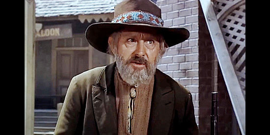 John Qualen as Jonas P. Travis, the old-timer who watches over the graveyard in the ghost town in Ambush at Tomahawk Gap (1953)