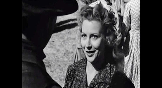 Julie Bishop as Laurie Smith, turning down a womanizing cowpoke who asks for a dance in Westward the Women (1951)