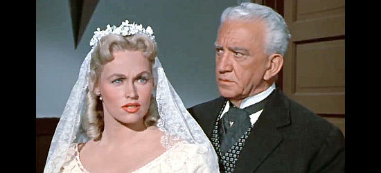 Karen Steele as Lucy Summerton, surprised to have her wedding interrupted as her father (John Litel) looks on in Decision at Sundown (1957)