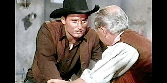 Keith Larsen as The Kid, getting information from bartender Manuel in the town where he often hides out in Son of Belle Starr (1953)