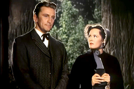 Kirk Douglas as Jim Fallon and Eve Miller as Alicia Chadwick among the trees he's trying to cut and she's trying to save in The Big Trees (1952)