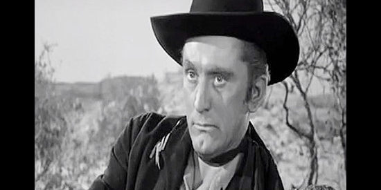 Kirk Douglas as Marshal Len Merrick, learning there's a lynching to stop in Along the Great Divide (1951)